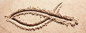 Christian fish symbol in sand